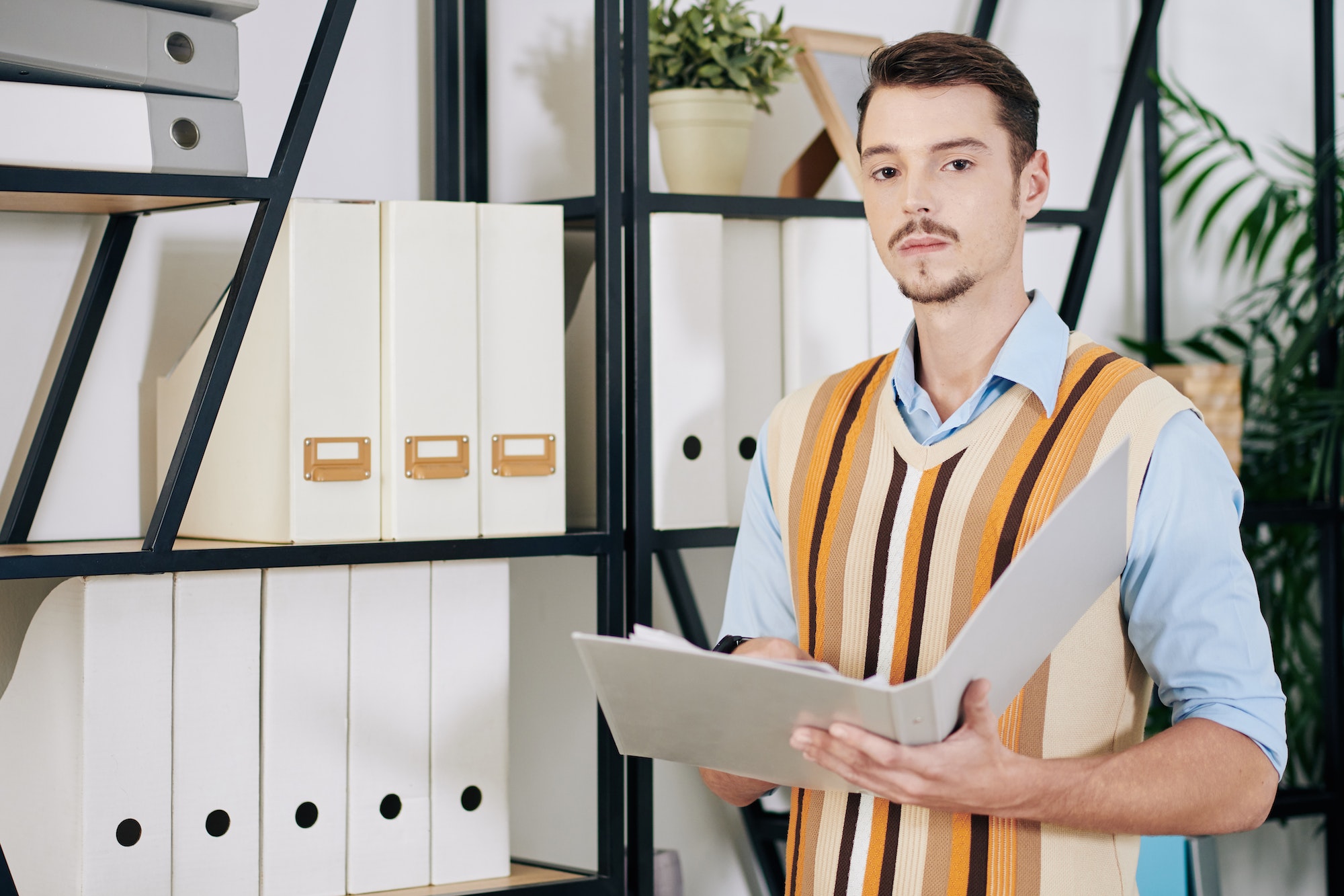 Businessman searching for document in archive